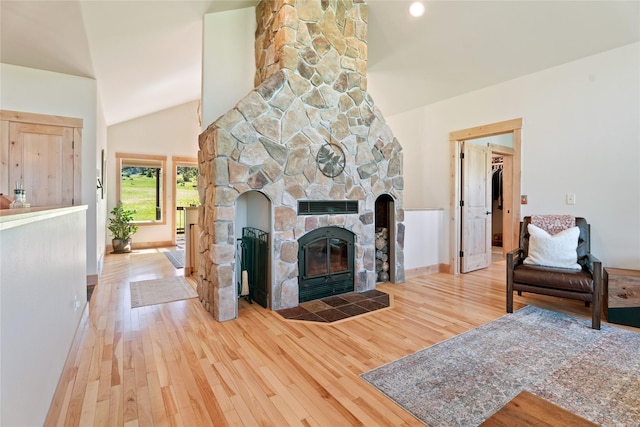 36 Lost Trl, Clancy, MT 59634 - living area with wood finished floors, a fireplace, lofted ceiling, and baseboards