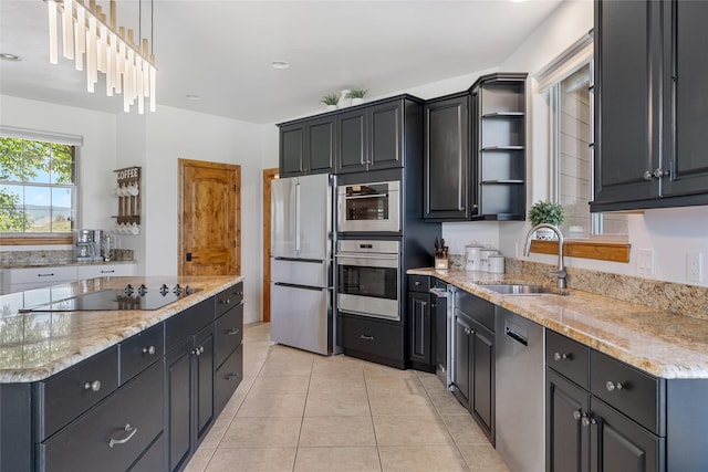 310 Jossie Ln, Kalispell, MT 59901 - kitchen featuring stainless steel appliances, a sink, open shelves, light stone counters, and light tile patterned floors