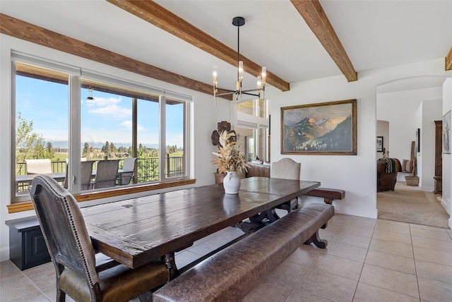 310 Jossie Ln, Kalispell, MT 59901 - dining space with a chandelier, beamed ceiling, light colored carpet, and light tile patterned flooring