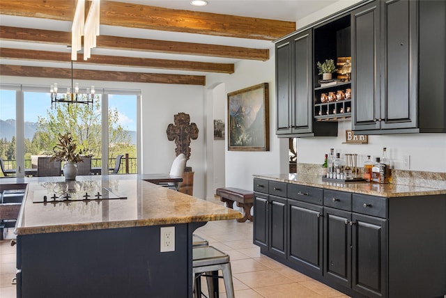 310 Jossie Ln, Kalispell, MT 59901 - kitchen featuring dark cabinetry, light tile patterned flooring, a kitchen breakfast bar, beamed ceiling, and recessed lighting