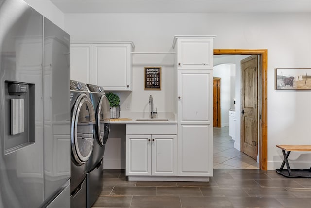 310 Jossie Ln, Kalispell, MT 59901 - washroom with washer and clothes dryer, cabinet space, and baseboards