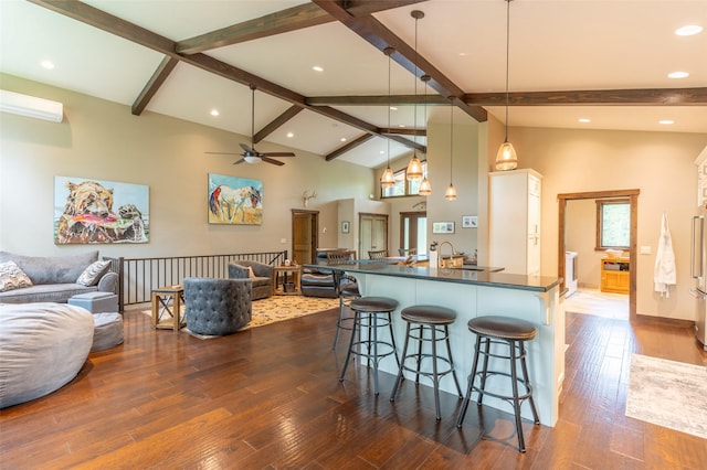 161 Hastings Trl, Columbia Falls, MT 59912 - kitchen with dark countertops, open floor plan, a breakfast bar, ceiling fan, and a sink