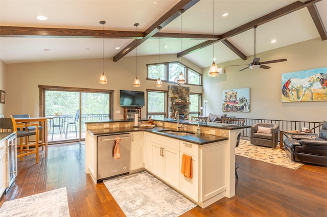 161 Hastings Trl, Columbia Falls, MT 59912 - kitchen with stainless steel dishwasher, a sink, open floor plan, dark wood-style floors, and beamed ceiling
