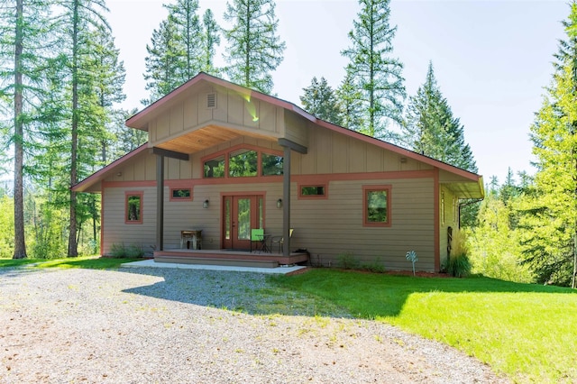 161 Hastings Trl, Columbia Falls, MT 59912 - view of front of property with french doors, board and batten siding, a front lawn, and driveway