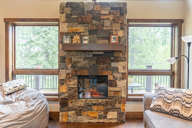 161 Hastings Trl, Columbia Falls, MT 59912 - living area featuring wood finished floors, baseboards, and a stone fireplace