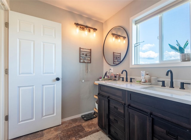 333 Darwin Rd, Helena, MT 59602 - full bath featuring double vanity, baseboards, and stone finish floors