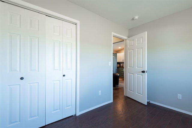333 Darwin Rd, Helena, MT 59602 - unfurnished bedroom featuring baseboards, a closet, and dark wood-style flooring