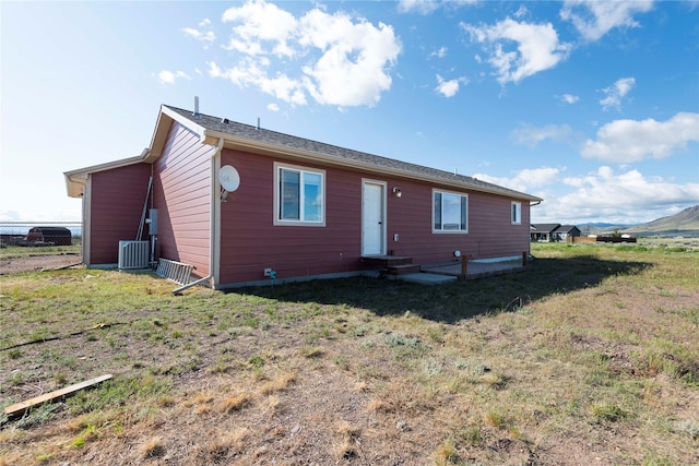 333 Darwin Rd, Helena, MT 59602 - back of house featuring entry steps, cooling unit, and a lawn
