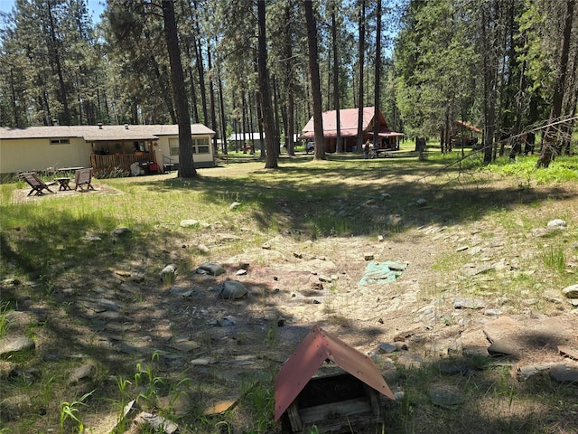 226 Powerline Way, Libby, MT 59923 - view of yard featuring a view of trees and an outdoor fire pit