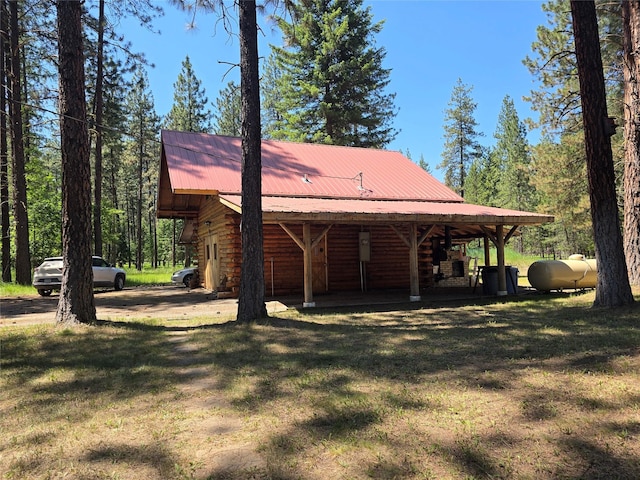 226 Powerline Way, Libby, MT 59923 - view of home's exterior featuring a metal roof, a yard, and log siding