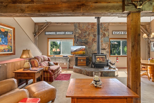 29 Gold Coin Rd, Hall, MT 59837 - living room featuring carpet flooring, a wood stove, and plenty of natural light