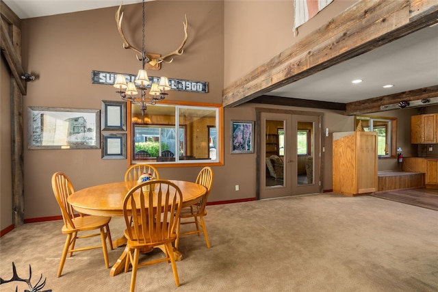 29 Gold Coin Rd, Hall, MT 59837 - dining space featuring baseboards, light carpet, a chandelier, french doors, and beamed ceiling
