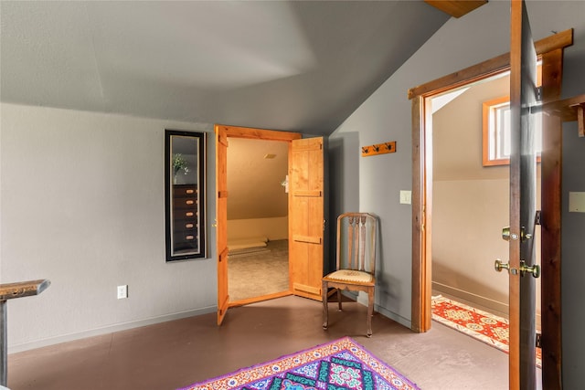 29 Gold Coin Rd, Hall, MT 59837 - unfurnished room featuring vaulted ceiling, concrete floors, and baseboards