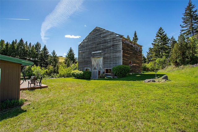 29 Gold Coin Rd, Hall, MT 59837 - view of grassy yard featuring a barn, an outbuilding, and a wooden deck