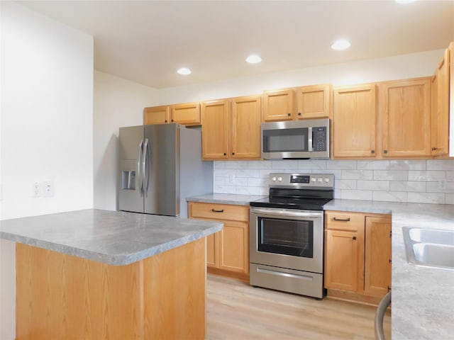 1960/1962 Greatview Dr, Kalispell, MT 59901 - kitchen with stainless steel appliances, backsplash, light wood-style floors, light brown cabinets, and recessed lighting