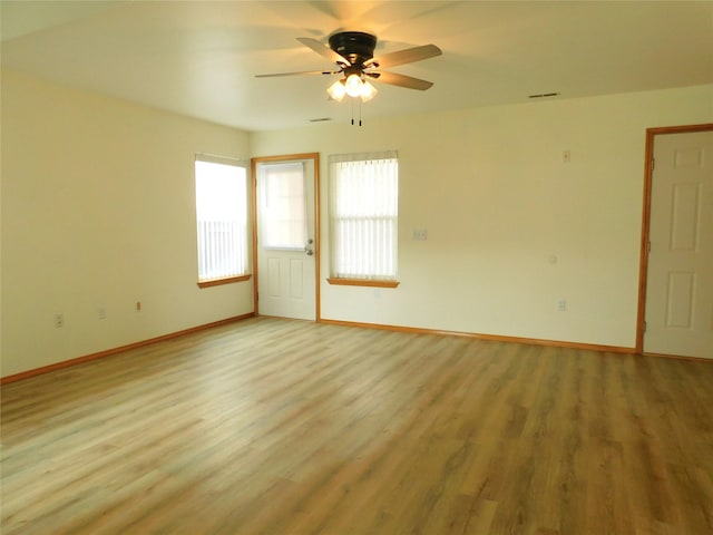 1960/1962 Greatview Dr, Kalispell, MT 59901 - empty room featuring baseboards, light wood-style flooring, and a ceiling fan