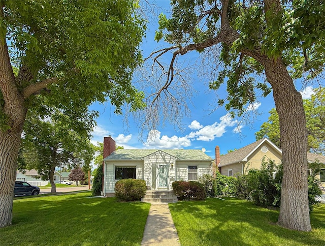 2201 6th Ave N, Great Falls, MT 59401 - view of front of house with a front lawn and a chimney