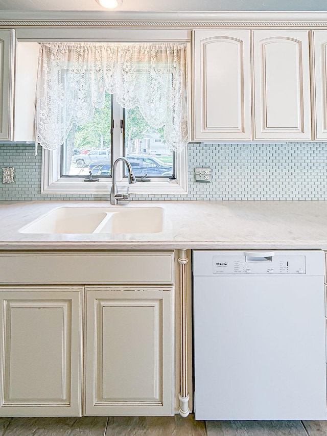 2201 6th Ave N, Great Falls, MT 59401 - kitchen with dishwasher, a sink, light countertops, and decorative backsplash