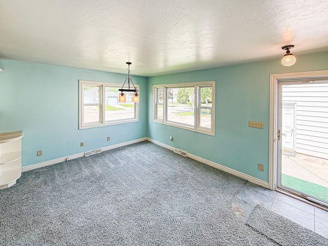 2201 6th Ave N, Great Falls, MT 59401 - unfurnished dining area with a textured ceiling, baseboards, and carpet flooring