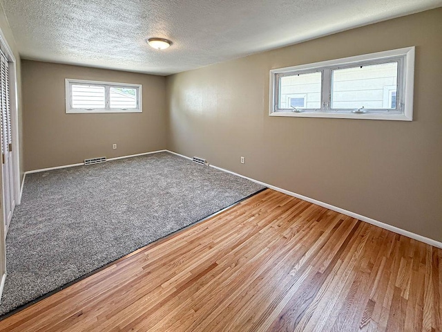 2201 6th Ave N, Great Falls, MT 59401 - spare room with baseboards, wood finished floors, and a textured ceiling