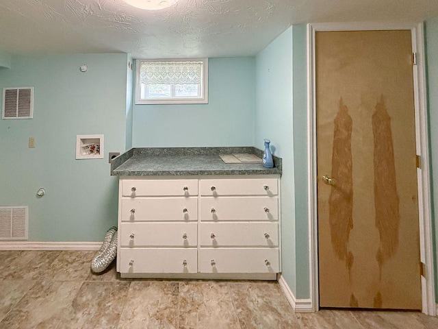 2201 6th Ave N, Great Falls, MT 59401 - laundry area featuring washer hookup, cabinet space, and baseboards