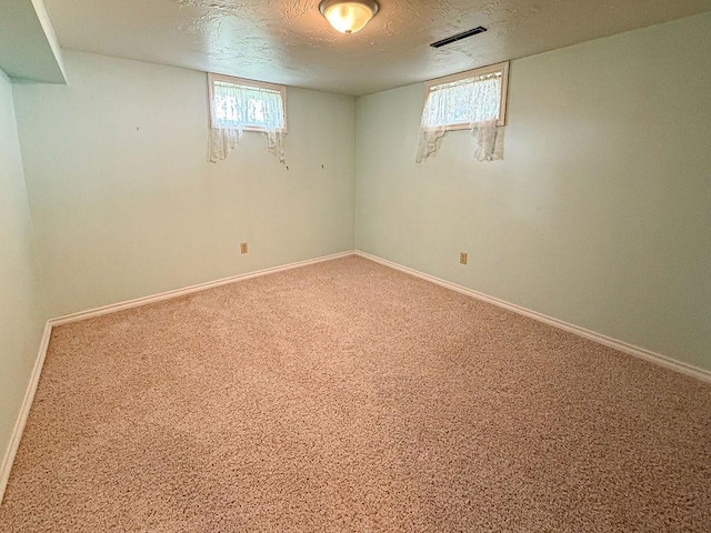 2201 6th Ave N, Great Falls, MT 59401 - basement featuring a textured ceiling, baseboards, and carpet flooring