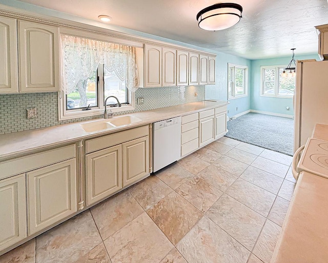 2201 6th Ave N, Great Falls, MT 59401 - kitchen featuring white appliances, a sink, cream cabinetry, and baseboards