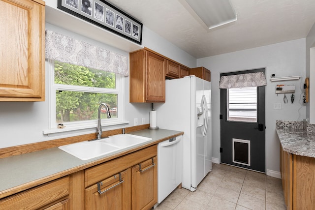2713 5th Ave S, Great Falls, MT 59405 - kitchen featuring white appliances, a sink, light tile patterned floors, light countertops, and baseboards