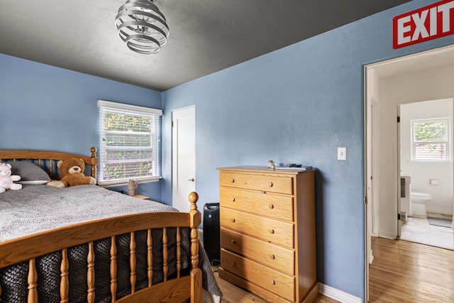 2713 5th Ave S, Great Falls, MT 59405 - bedroom with wood finished floors, multiple windows, and baseboards