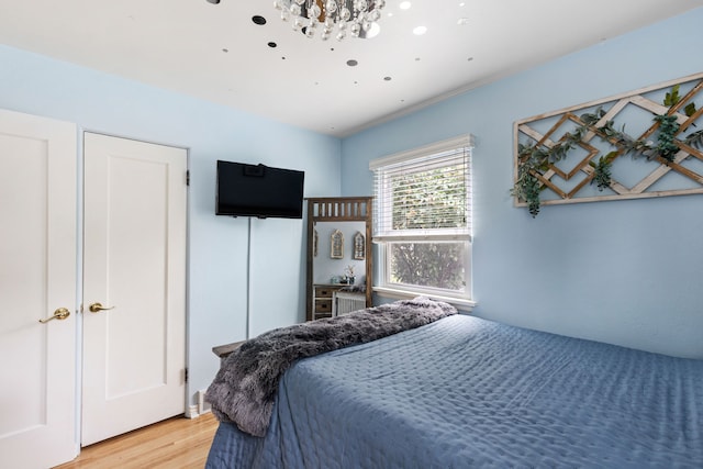 2713 5th Ave S, Great Falls, MT 59405 - bedroom with light wood-style flooring and a chandelier