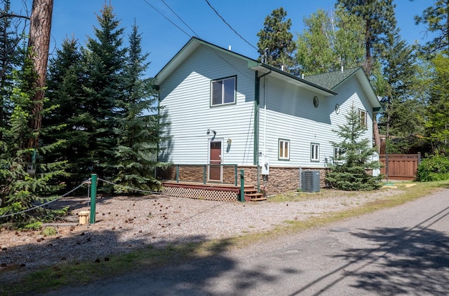 37817 Kings Point Rd, Polson, MT 59860 - view of property exterior featuring stone siding and cooling unit