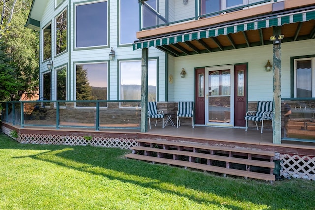 37817 Kings Point Rd, Polson, MT 59860 - doorway to property featuring a lawn and a porch