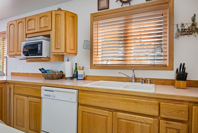 37817 Kings Point Rd, Polson, MT 59860 - kitchen with white dishwasher, stainless steel microwave, a sink, and light countertops