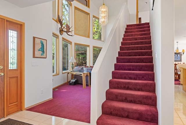 37817 Kings Point Rd, Polson, MT 59860 - foyer featuring healthy amount of natural light, stairs, light colored carpet, and light tile patterned floors