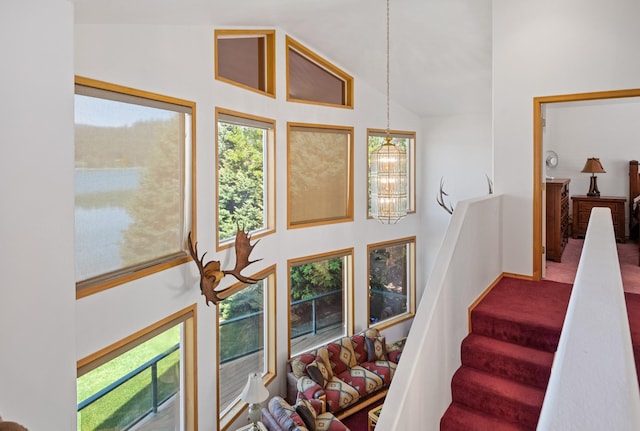 37817 Kings Point Rd, Polson, MT 59860 - staircase with high vaulted ceiling and a chandelier