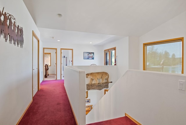 37817 Kings Point Rd, Polson, MT 59860 - hallway with an upstairs landing, plenty of natural light, dark colored carpet, recessed lighting, and baseboards