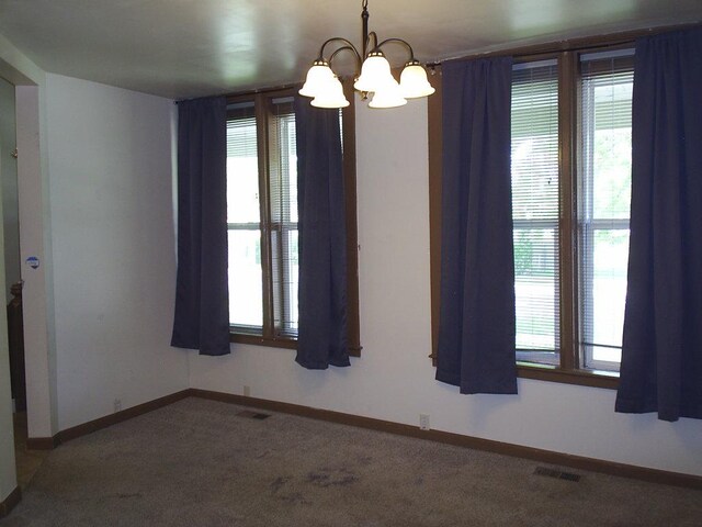 619 E Broadway St, Helena, MT 59601 - carpeted empty room featuring a chandelier and baseboards