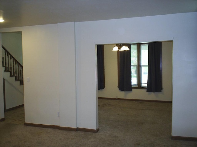 619 E Broadway St, Helena, MT 59601 - empty room with carpet floors, a chandelier, stairs, and baseboards