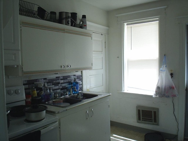 619 E Broadway St, Helena, MT 59601 - kitchen with electric range, backsplash, white cabinetry, and a sink