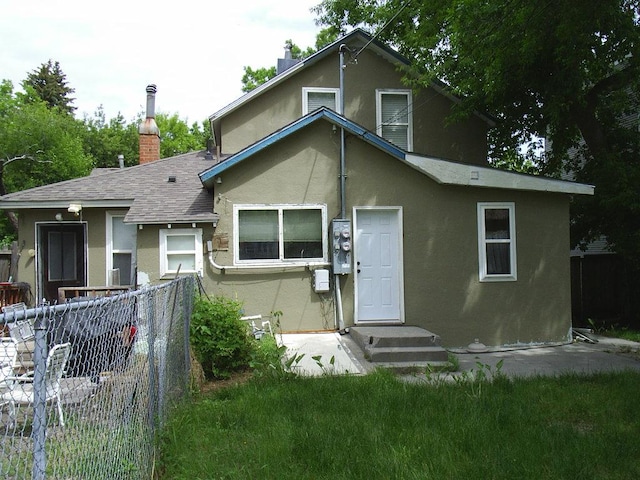 619 E Broadway St, Helena, MT 59601 - view of front of home with stucco siding, a shingled roof, and a chimney