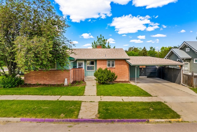 122 22nd St S, Great Falls, MT 59401 - view of front of property featuring an attached carport, brick siding, concrete driveway, and a chimney