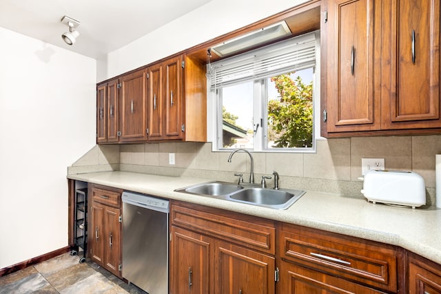 122 22nd St S, Great Falls, MT 59401 - kitchen featuring stainless steel dishwasher, a sink, decorative backsplash, light countertops, and brown cabinets