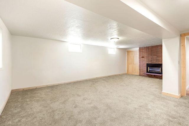 122 22nd St S, Great Falls, MT 59401 - unfurnished living room with a brick fireplace, light colored carpet, baseboards, and a textured ceiling