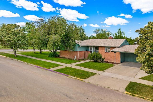 122 22nd St S, Great Falls, MT 59401 - view of front facade with brick siding, a chimney, concrete driveway, an attached carport, and a front lawn