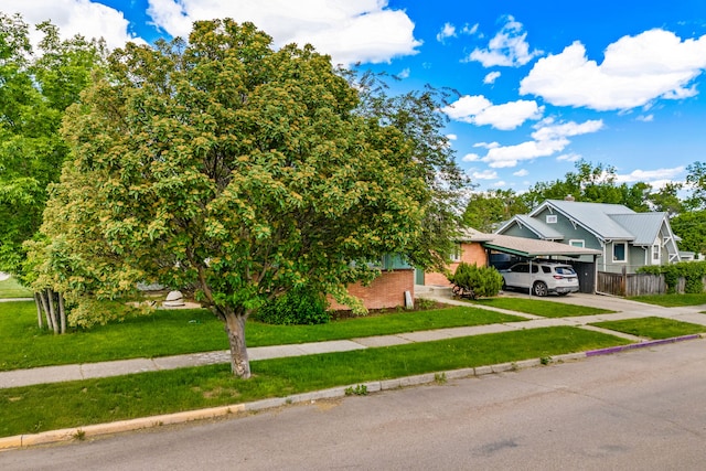 122 22nd St S, Great Falls, MT 59401 - obstructed view of property featuring driveway, brick siding, and a carport