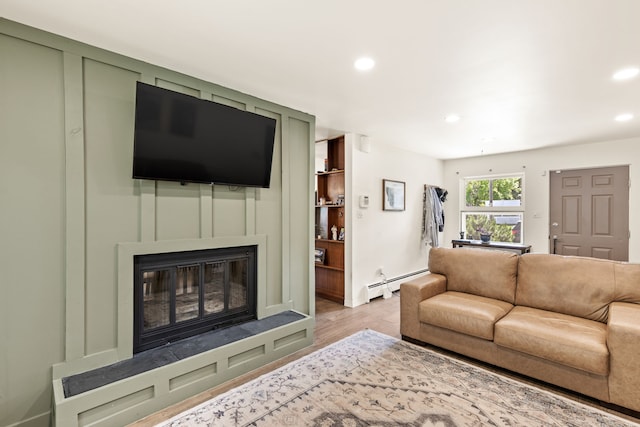 122 22nd St S, Great Falls, MT 59401 - living room with a baseboard radiator, recessed lighting, a glass covered fireplace, and light wood-type flooring