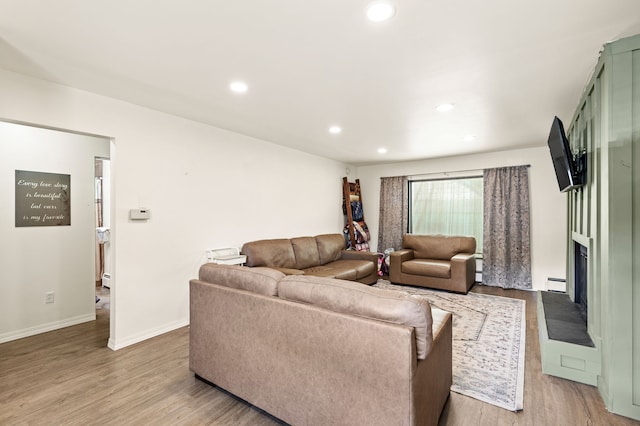 122 22nd St S, Great Falls, MT 59401 - living area featuring wood finished floors, a large fireplace, recessed lighting, baseboard heating, and baseboards