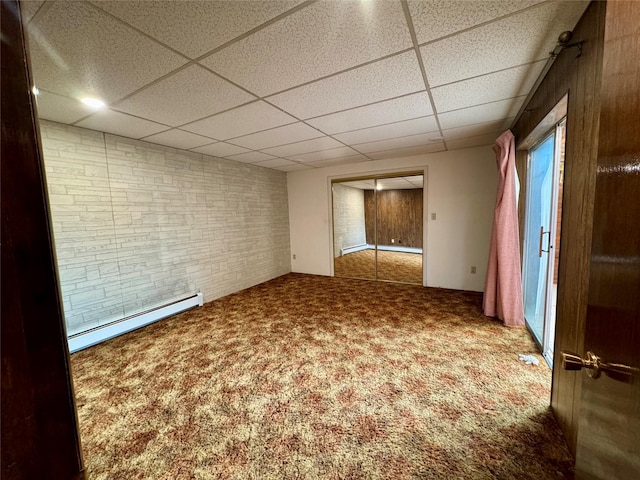 55 Equis Ln, Butte, MT 59701 - empty room with a drop ceiling, baseboard heating, and carpet flooring