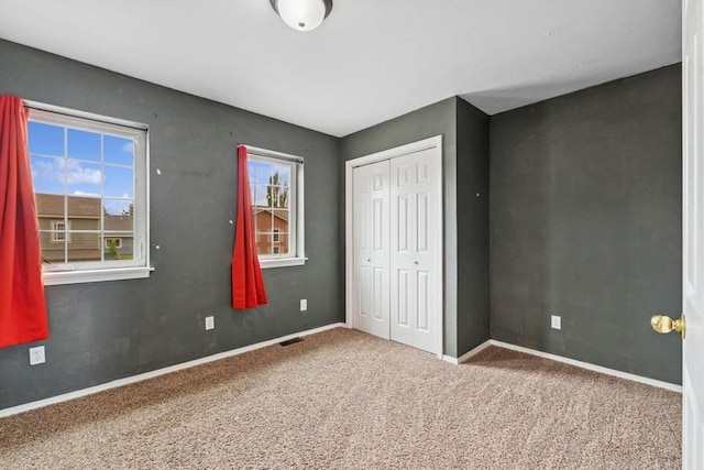 8 Mitchell Way, Columbia Falls, MT 59912 - unfurnished bedroom with a closet, carpet floors, and baseboards
