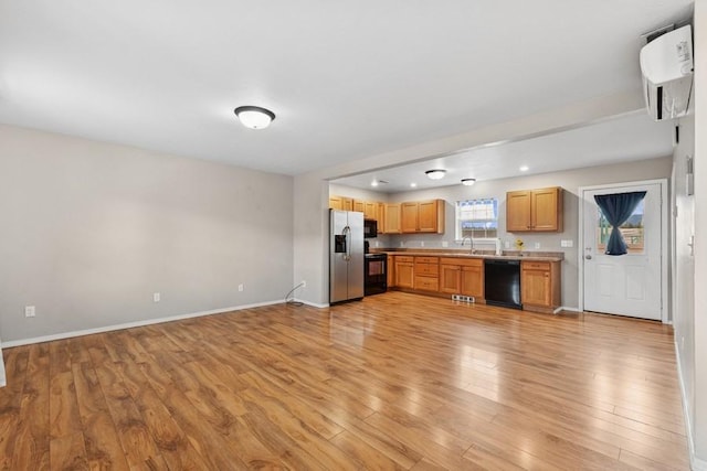 8 Mitchell Way, Columbia Falls, MT 59912 - kitchen featuring black appliances, light wood-style floors, light countertops, and baseboards
